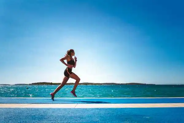Woman running showing strong leg muscle Coleshill
